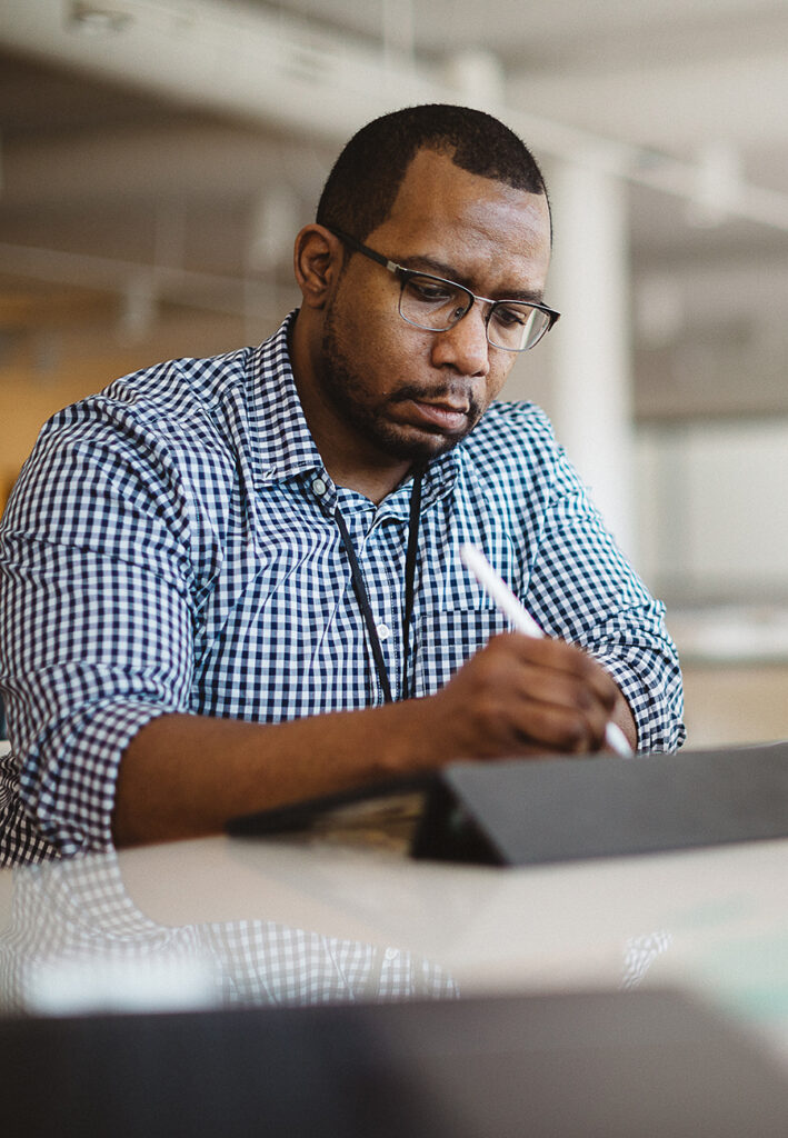Man working on a tablet using a stylus