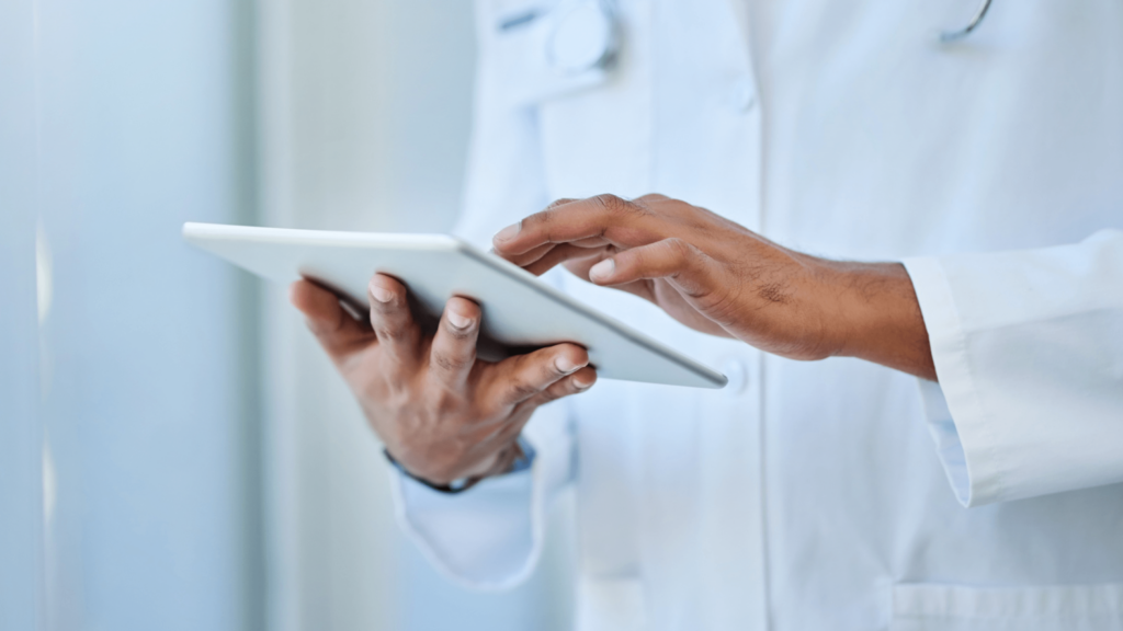 Doctor wearing a lab coat and using a tablet